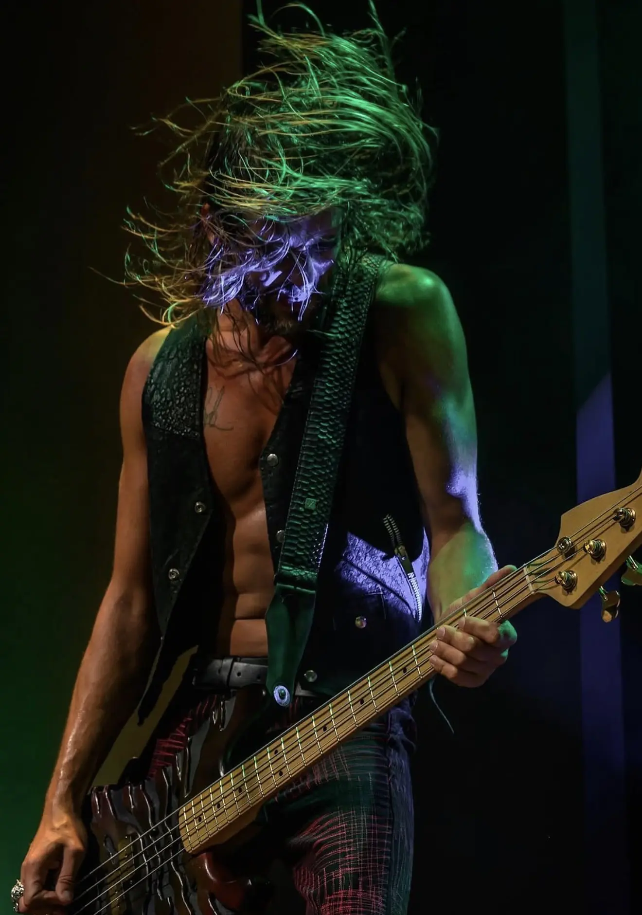 Jaron Gulino playing bass on stage
